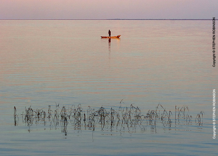 044_TZmN.8215-Lake-Bangweulu-Dawn-Fisherman-&-Canoe-N-Zambia