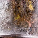 035_TZmN.7716-Man-Under-Waterfall-N-Zambia